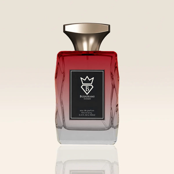 Red and clear perfume bottle with a black label on a beige background